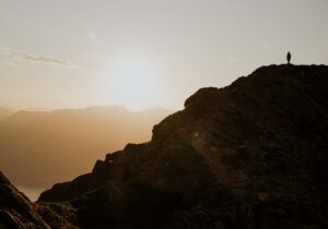 a small person on a distant mountain ridge against the rising sun - tag common creator mistakes to avoid