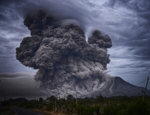 a raging volcano against a storm gray sky